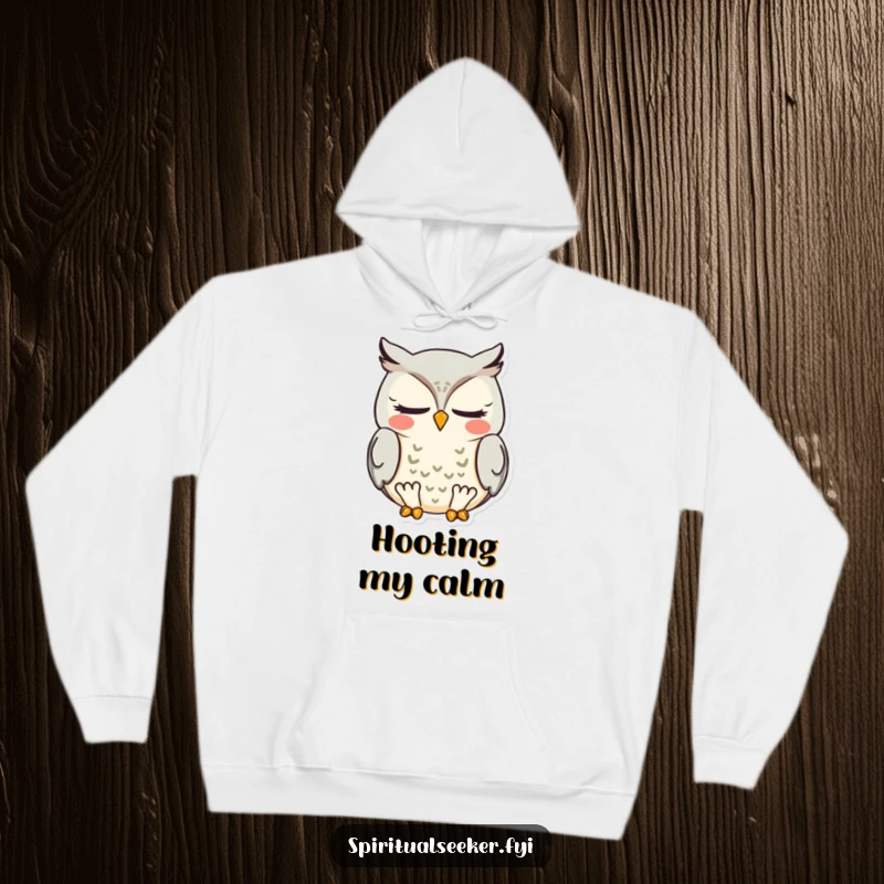 Funny meditating owl hoodie, featuring a wise bird in deep meditation with a blissful smile, offering warmth and humor.