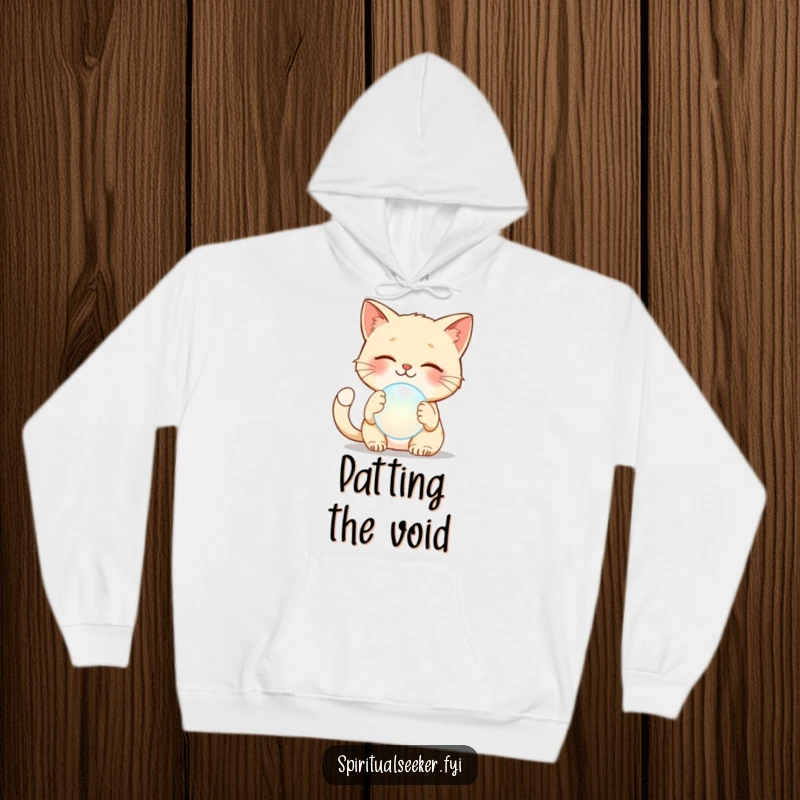Funny cat hoodie depicting a content cat gently patting a mysterious, floating ethereal orb, bringing humor and warmth.